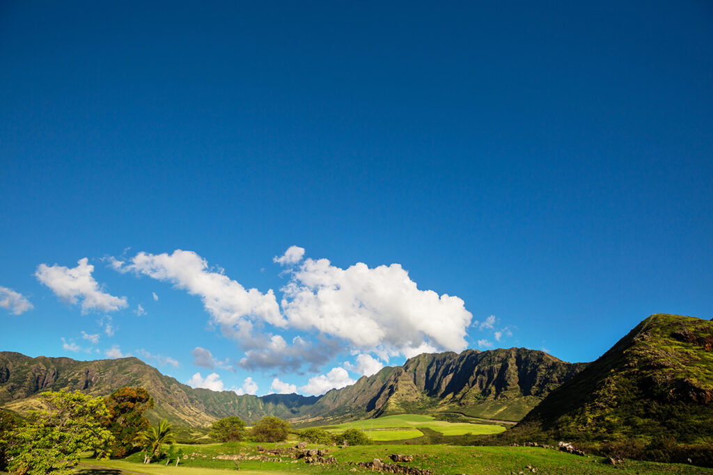 Farmland on Oahu with Lush Green Fields and Mountains in the Background